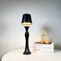 Decorative table lamp emitting warm amber glow on a wooden base