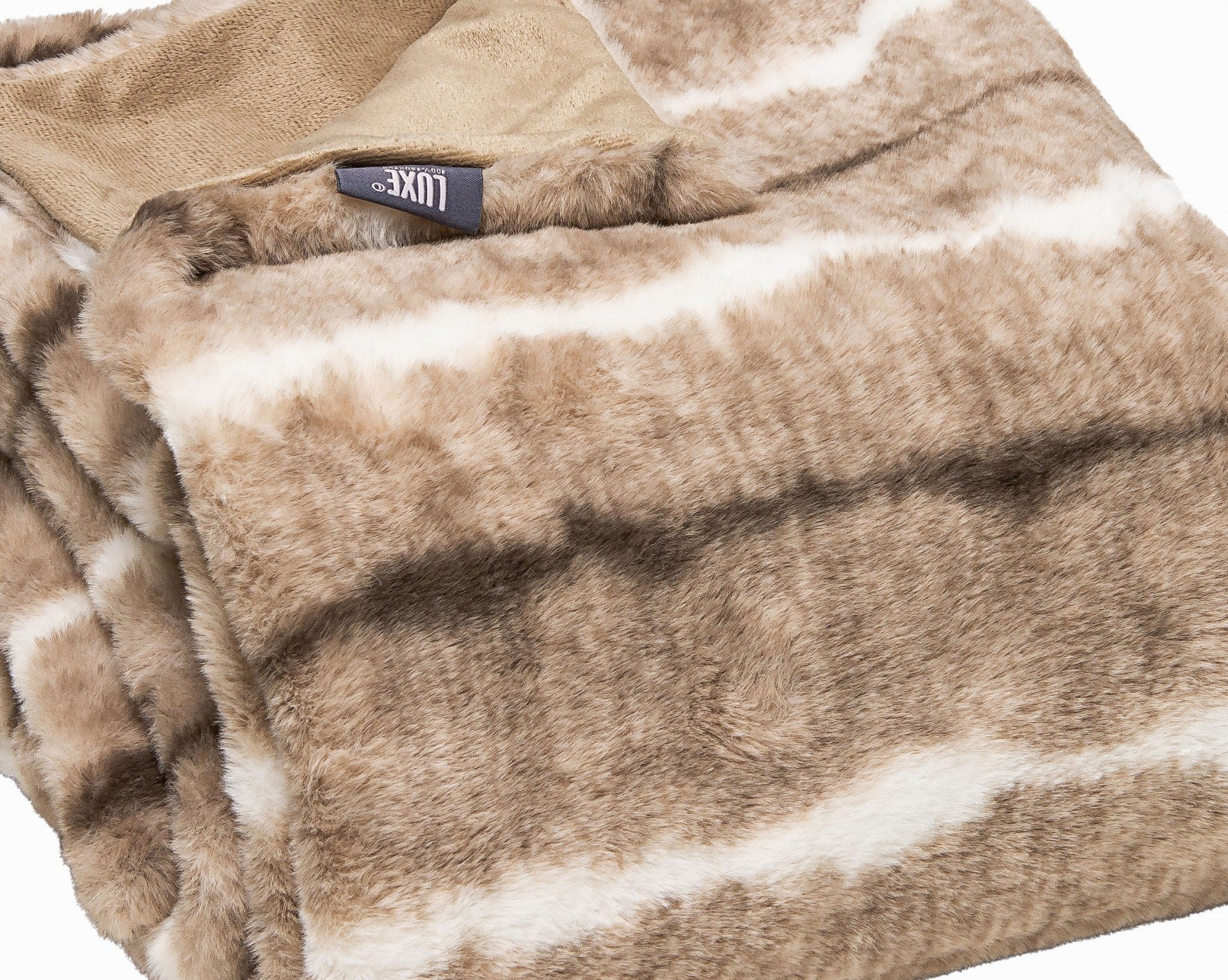Cream and light brown faux fur throw draped over a sofa or chair