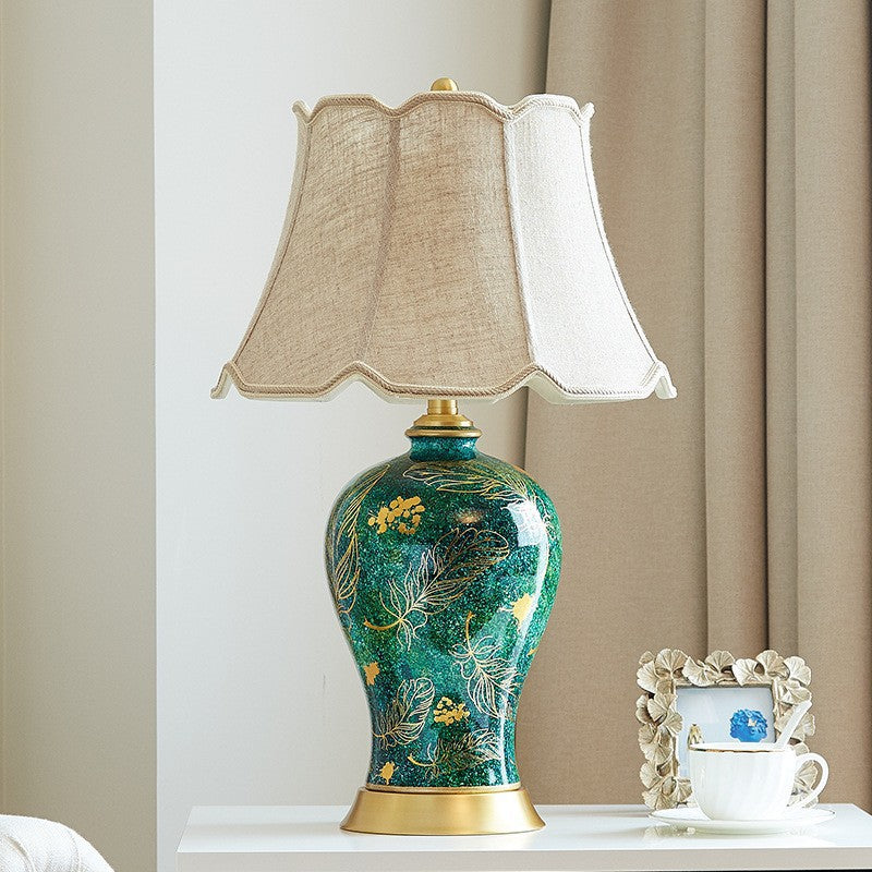 Ceramic bedside table lamp with a white fabric shade and warm-toned base