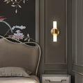 Wall lamp with warm-toned shade mounted on a neutral interior wall