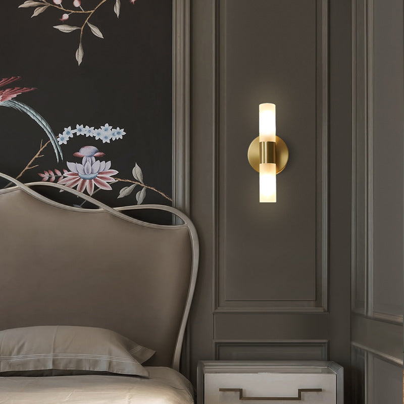 Wall lamp with warm-toned shade mounted on a neutral interior wall