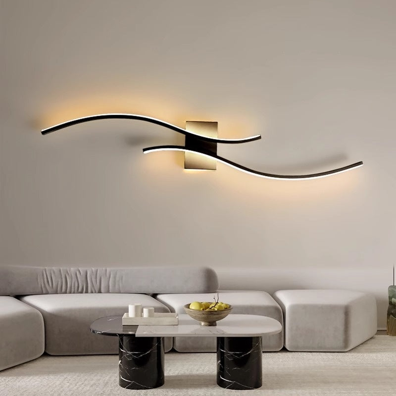 Long minimalist wall sconce with slim cylindrical shade in brushed metal finish