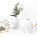 Irregular ceramic vase with white and grey marble-glaze finish