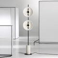 Floor lamp with cylindrical white marble base and neutral fabric shade