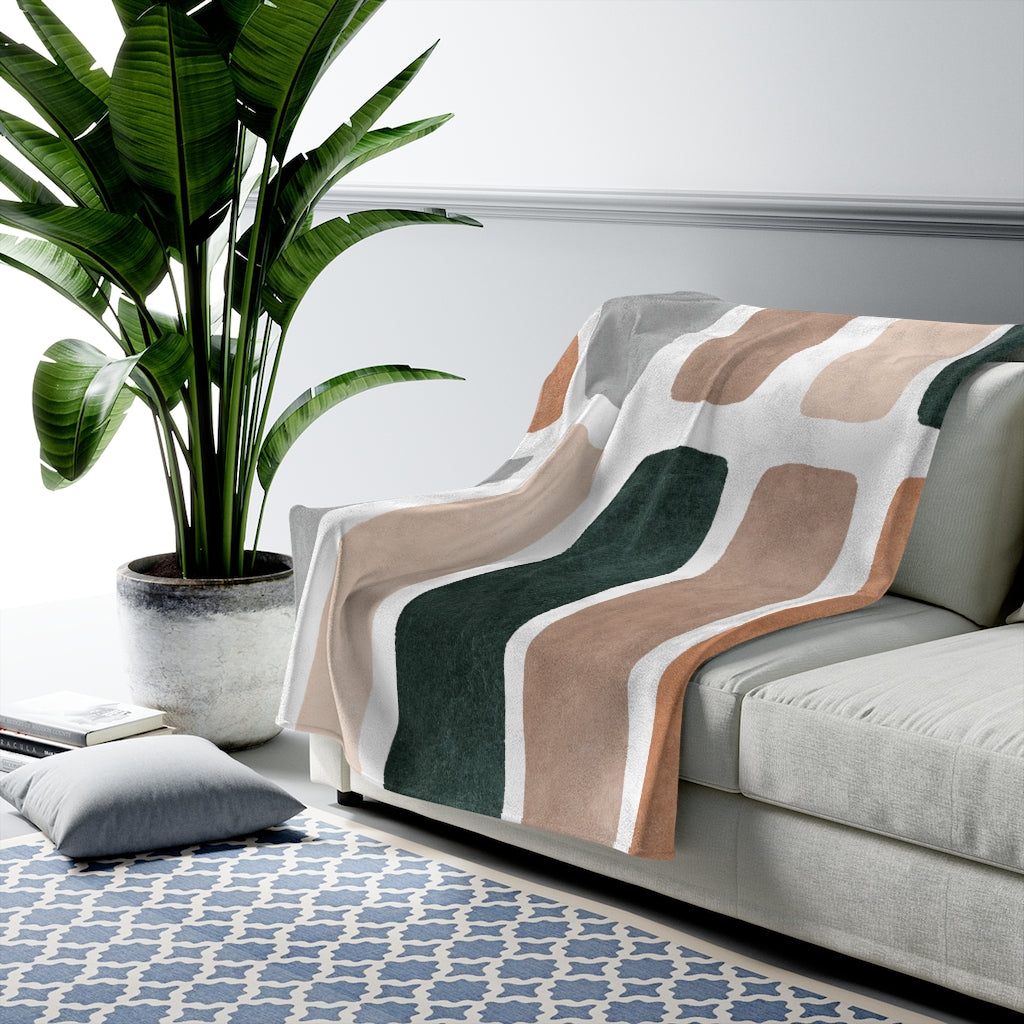 Plush velveteen throw blanket with abstract horizontal bar pattern in muted tones