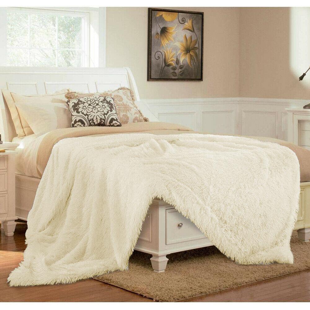 Reversible faux fur throw with plush cream and grey textured surface