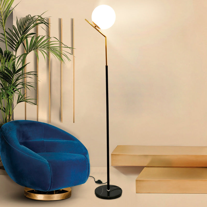 Floor-standing lamp emitting a warm amber glow on a white background