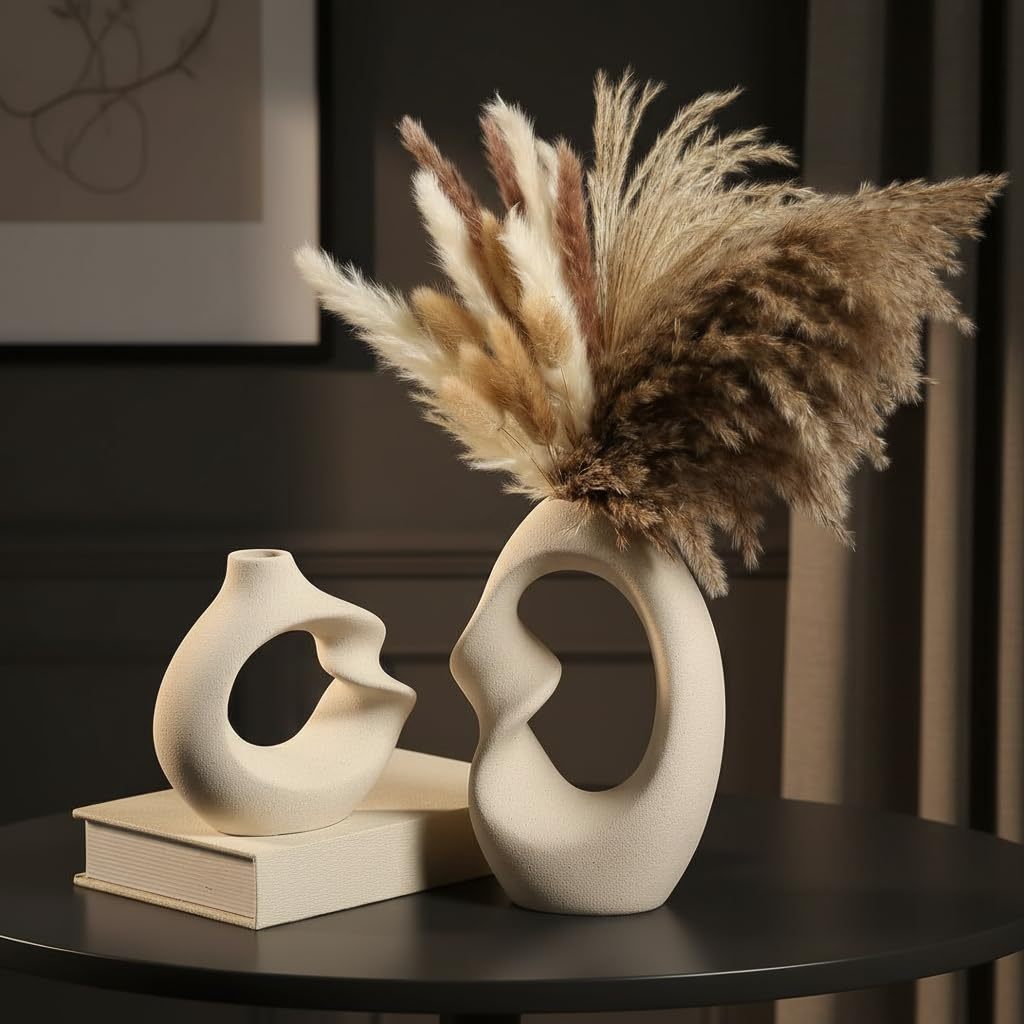 Two white ceramic vases in donut ring shapes, matte finish, displayed together