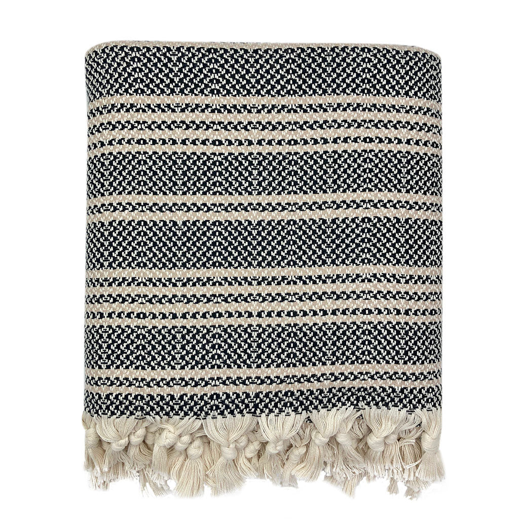 Woven stripe Turkish cotton throw in neutral tones, folded on a white surface